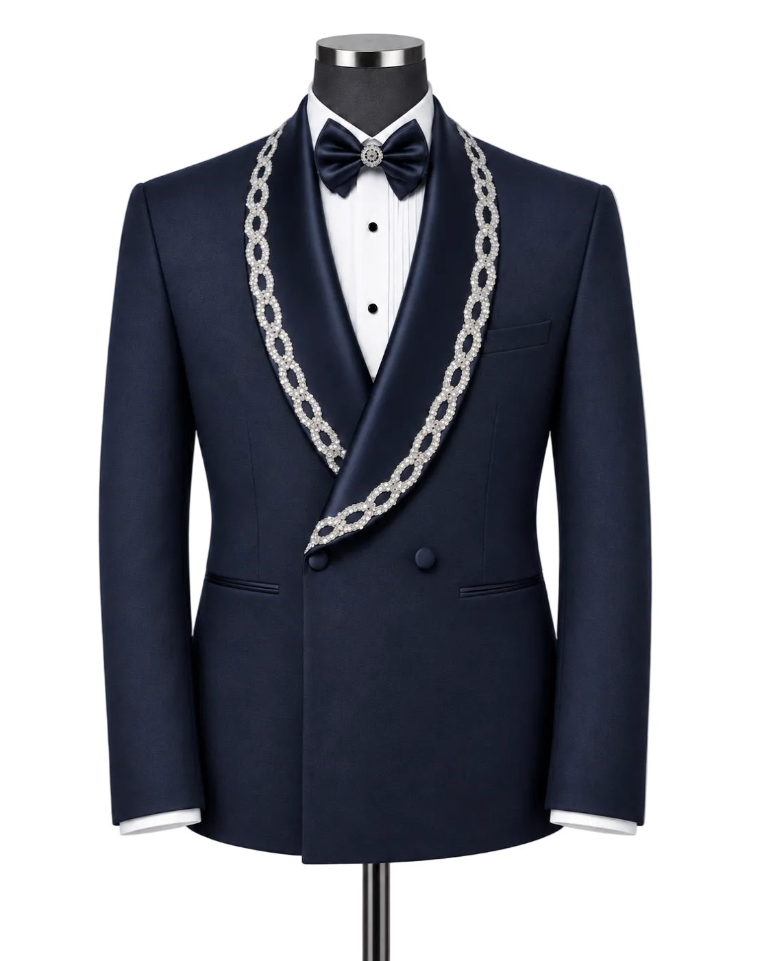 A navy blue satin tuxedo jacket displayed on a mannequin with a white dress shirt, a navy bow tie, and a prominent silver chain lapel. The jacket features a double-breasted design with a single front button and a decorative silver chain draped over the shoulders.