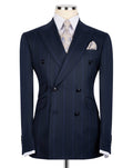 A navy blue double-breasted pinstripe suit jacket displayed on a mannequin torso, styled with a white dress shirt, a patterned beige tie, and a matching pocket square.