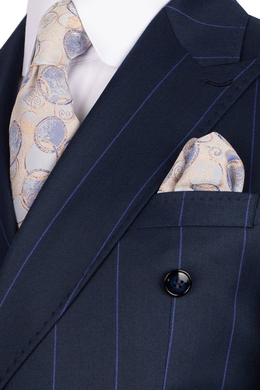 Navy pinstripe suit with patterned tie and pocket square on a mannequin.