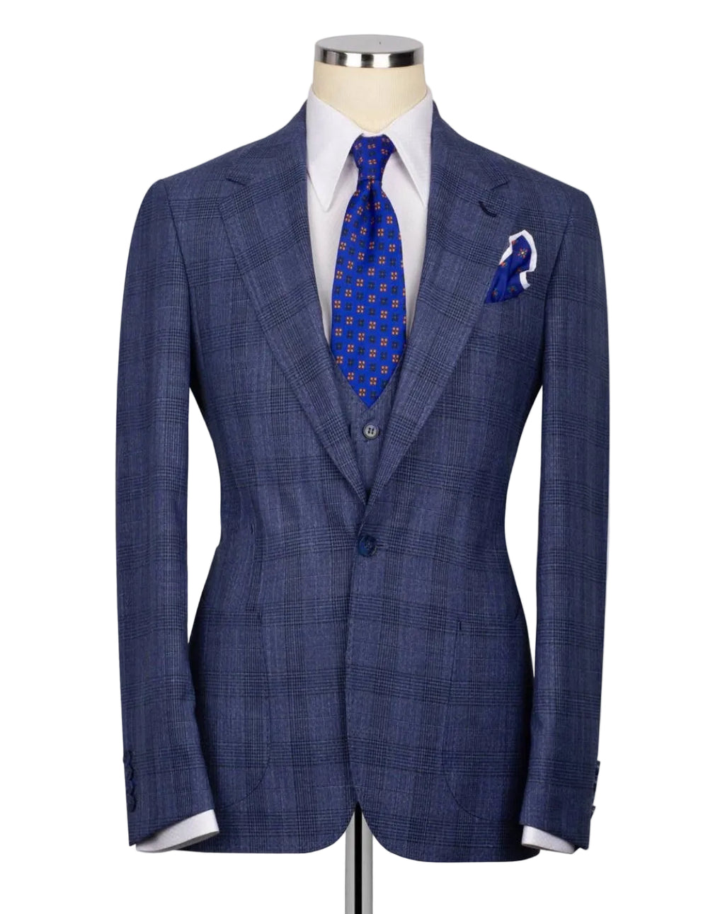 A blue windowpane plaid suit jacket displayed on a mannequin torso, styled with a white dress shirt, a blue patterned tie, and a matching pocket square.