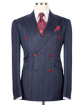 A navy blue double-breasted suit jacket with thin red pinstripes, styled on a mannequin with a white dress shirt, a red patterned tie, and a matching pocket square.