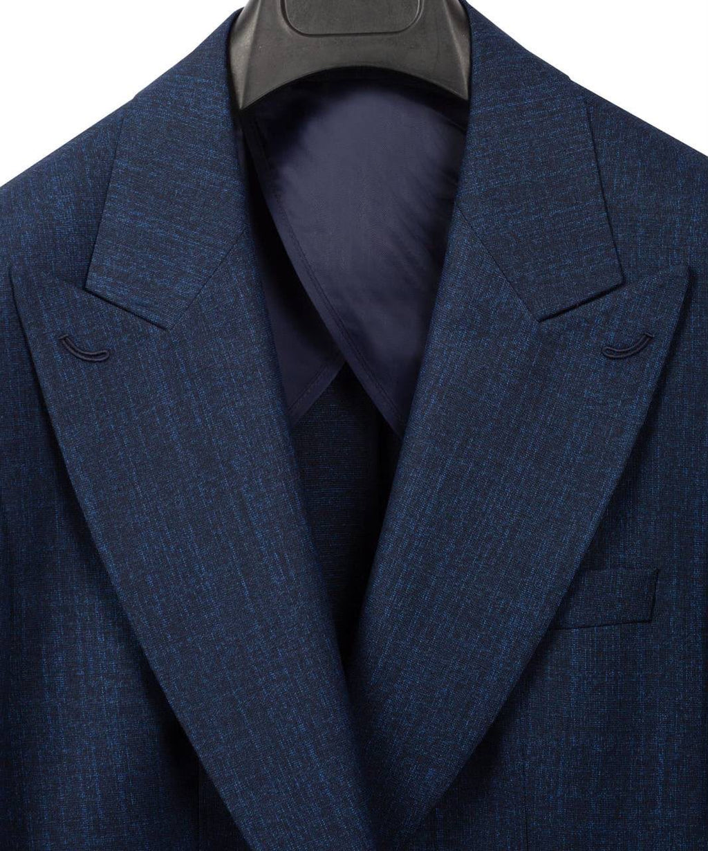 A close-up of a textured navy blue suit jacket with notched lapels, displayed on a black hanger against a white background.
