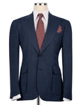 A navy blue textured suit jacket displayed on a mannequin torso, styled with a white dress shirt, a red and gold patterned tie, and a matching pocket square.