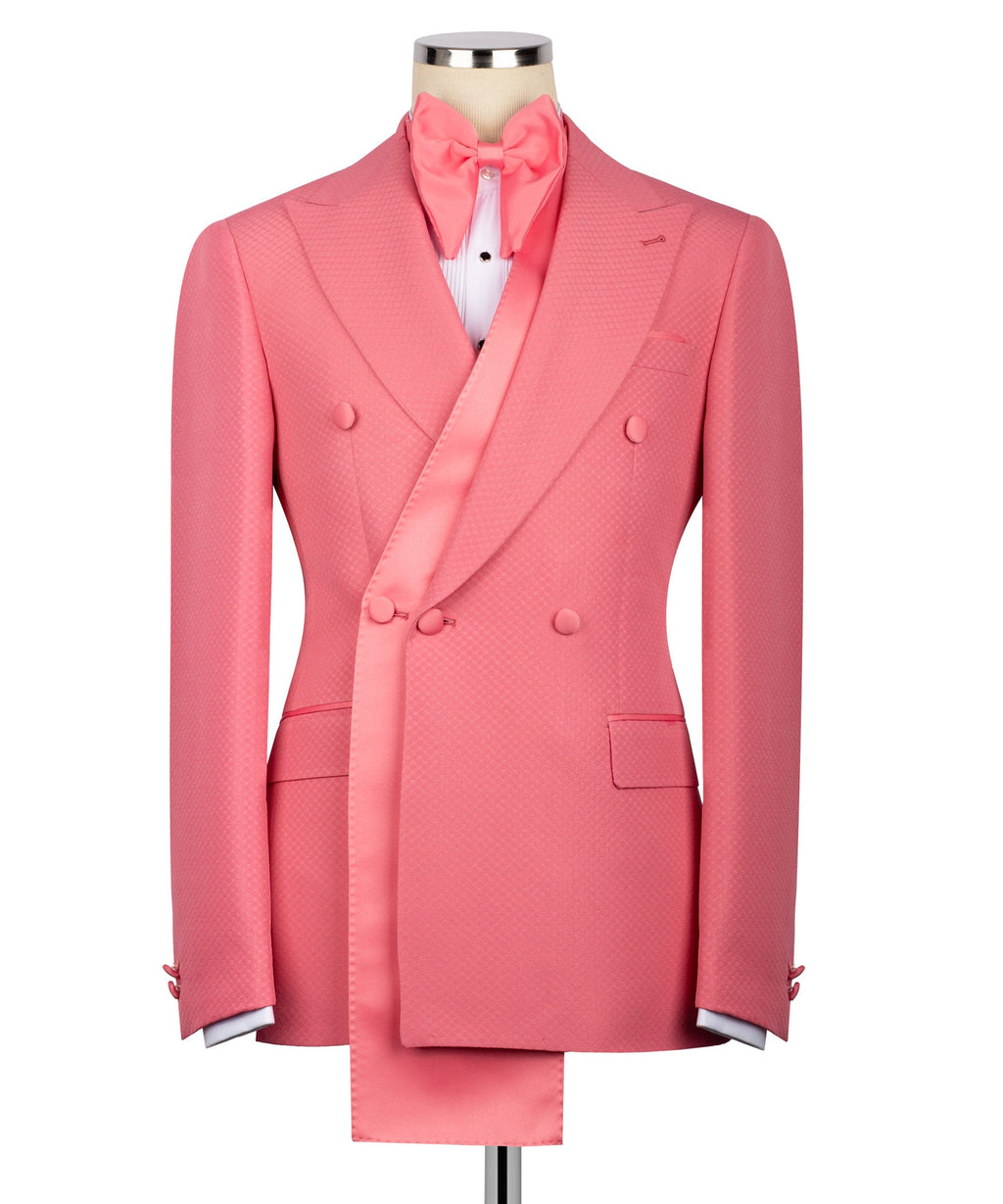 Pink tuxedo jacket with shawl lapel, double-breasted buttons, and pocket square