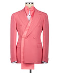 Pink tuxedo jacket with shawl lapel, double-breasted buttons, and pocket square