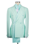 Long shawl lapel tuxedo jacket in light teal with bow and double-breasted styling