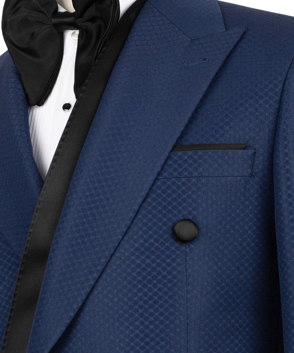 Close-up: blue tuxedo jacket with shawl lapel, black bow tie, textured fabric