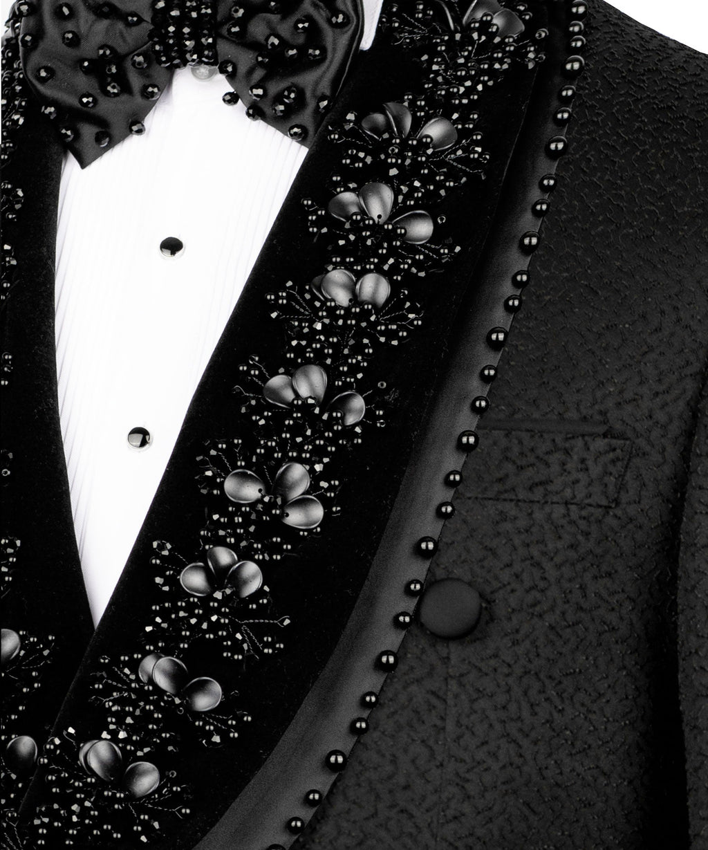 Close-up of stone and bead embroidery on tuxedo lapel with floral clusters