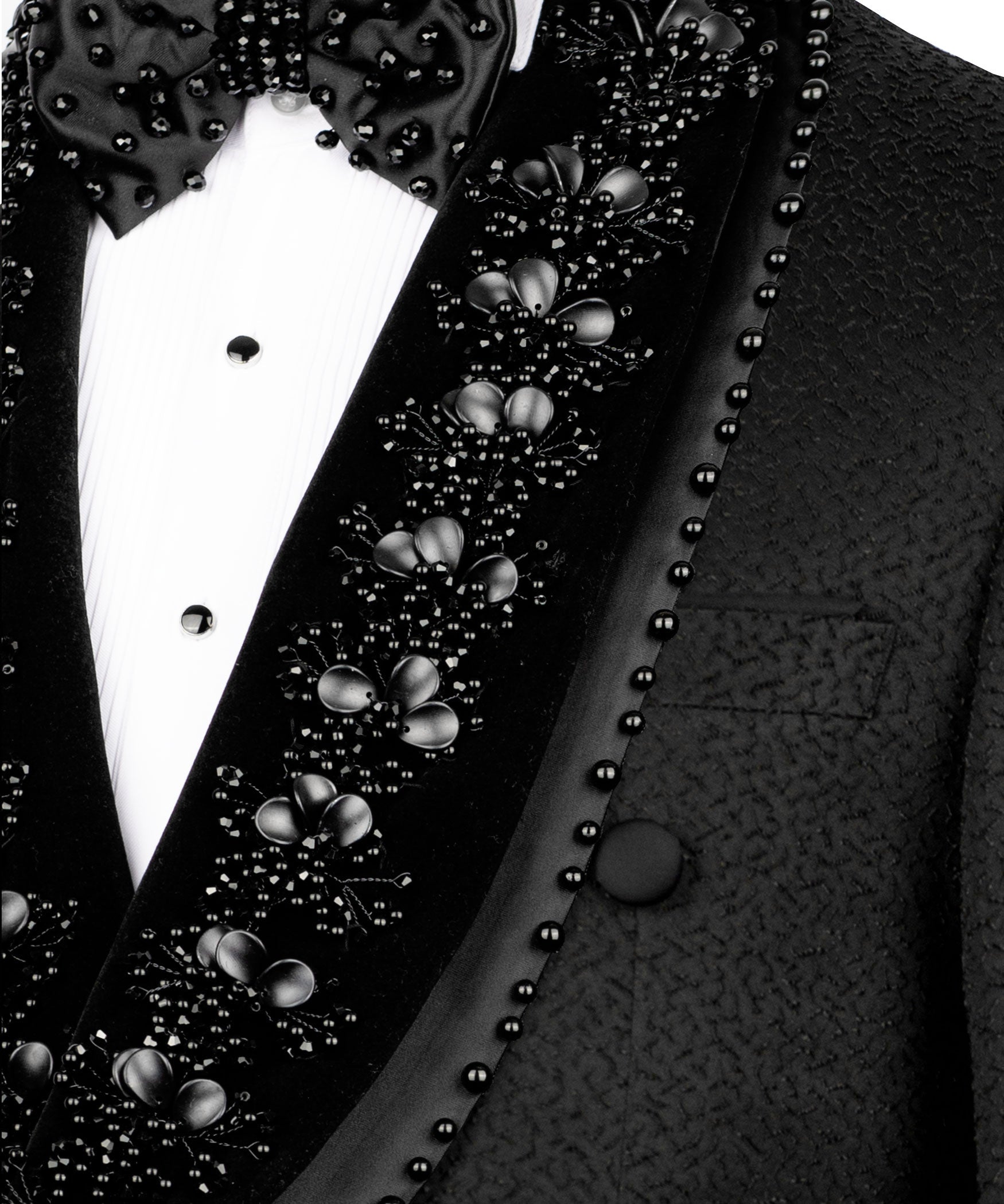 Close-up of stone and bead embroidery on tuxedo lapel with floral clusters