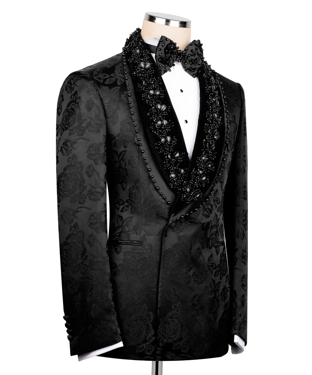 Black tuxedo jacket side view with floral damask pattern, studded trim and jeweled bow
