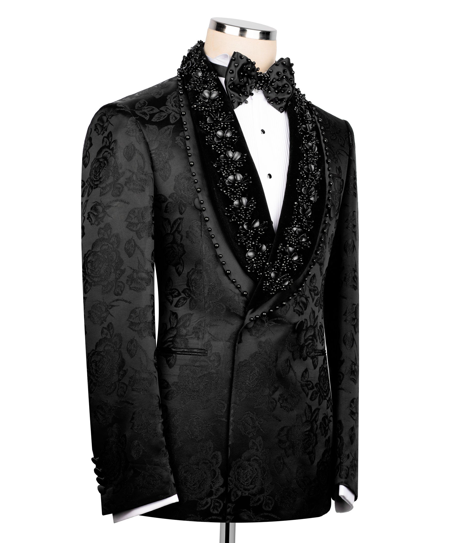 Black tuxedo jacket side view with floral damask pattern, studded trim and jeweled bow