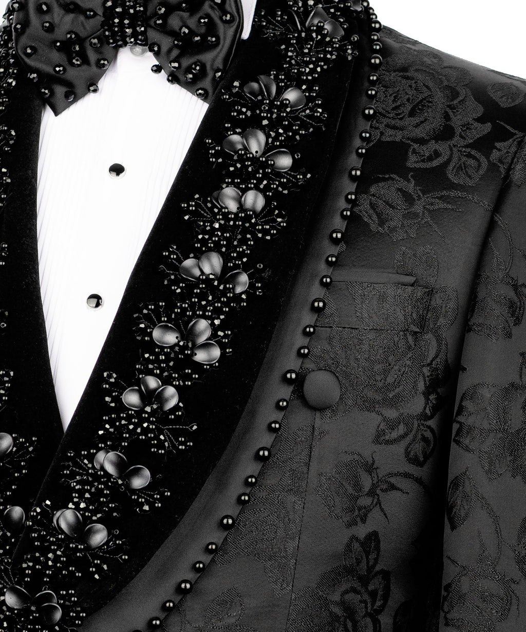 Close-up of black tuxedo lapel with studded trim, jeweled rosette embroidery and bow