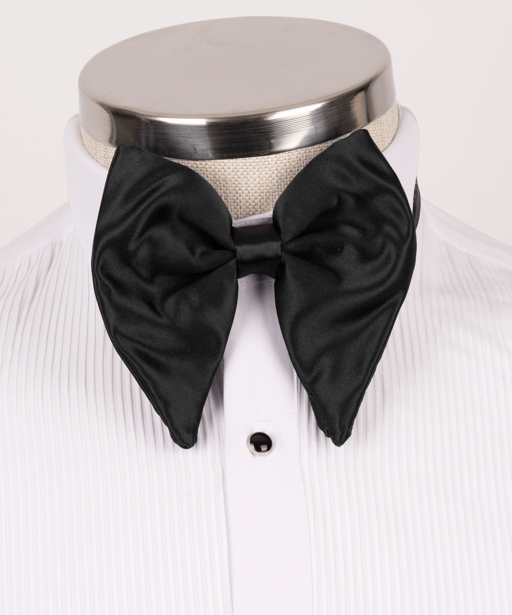 Black satin bow tie on white dress shirt with tuxedo stud buttons