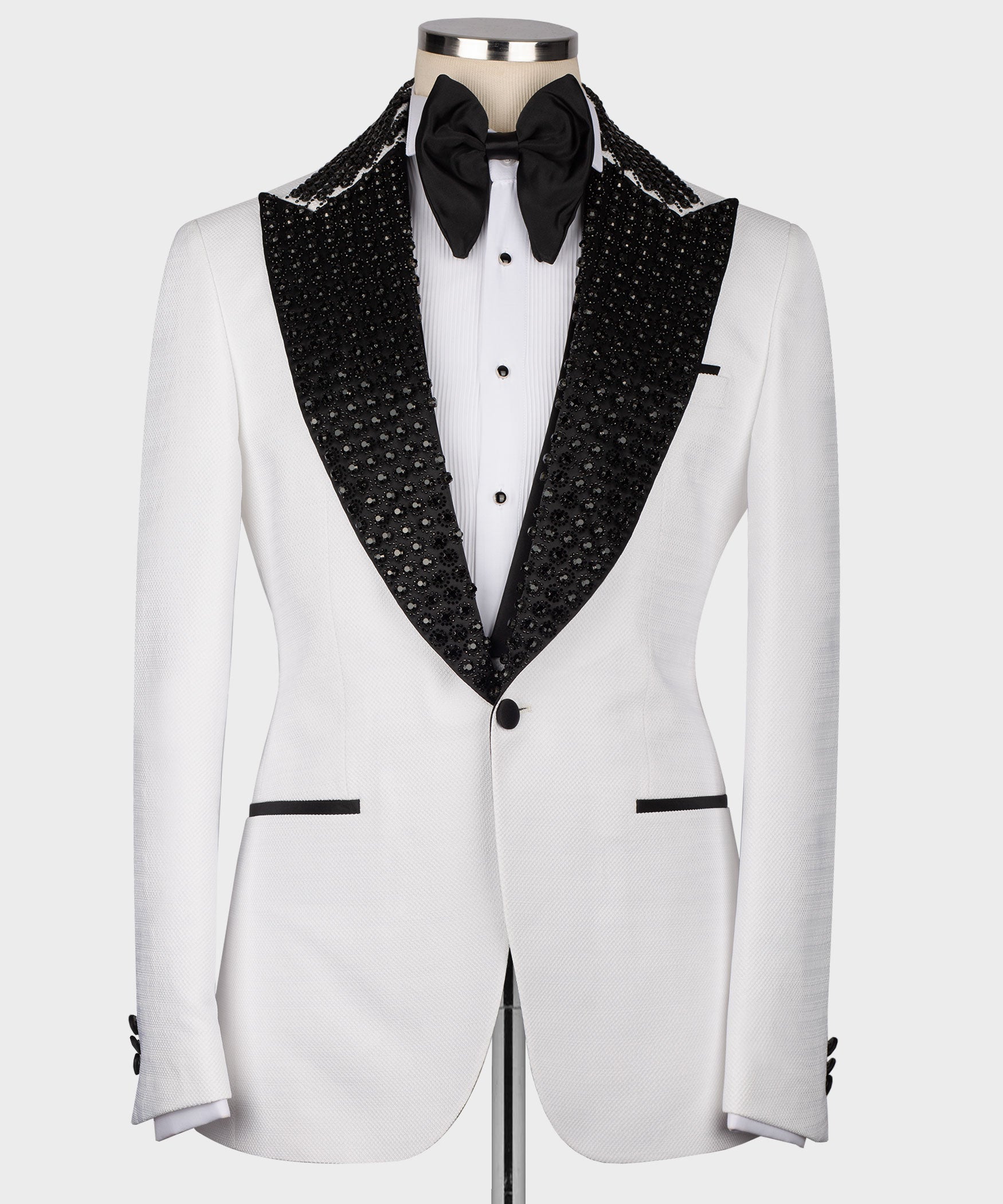 White tuxedo jacket with black stone-embroidered lapels and bow tie, front view