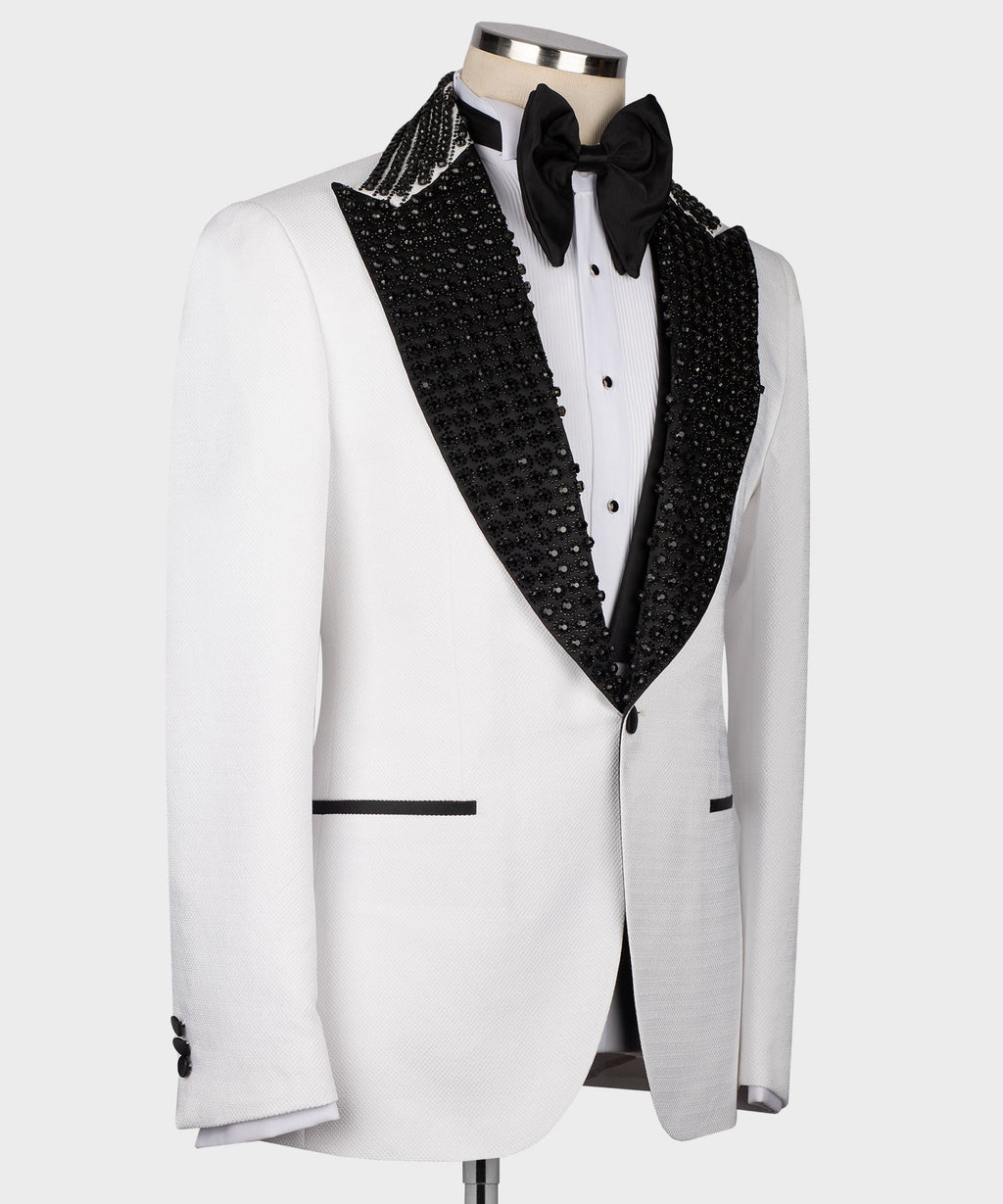 White tuxedo jacket with black lapel trim, bow tie, and three-button vest