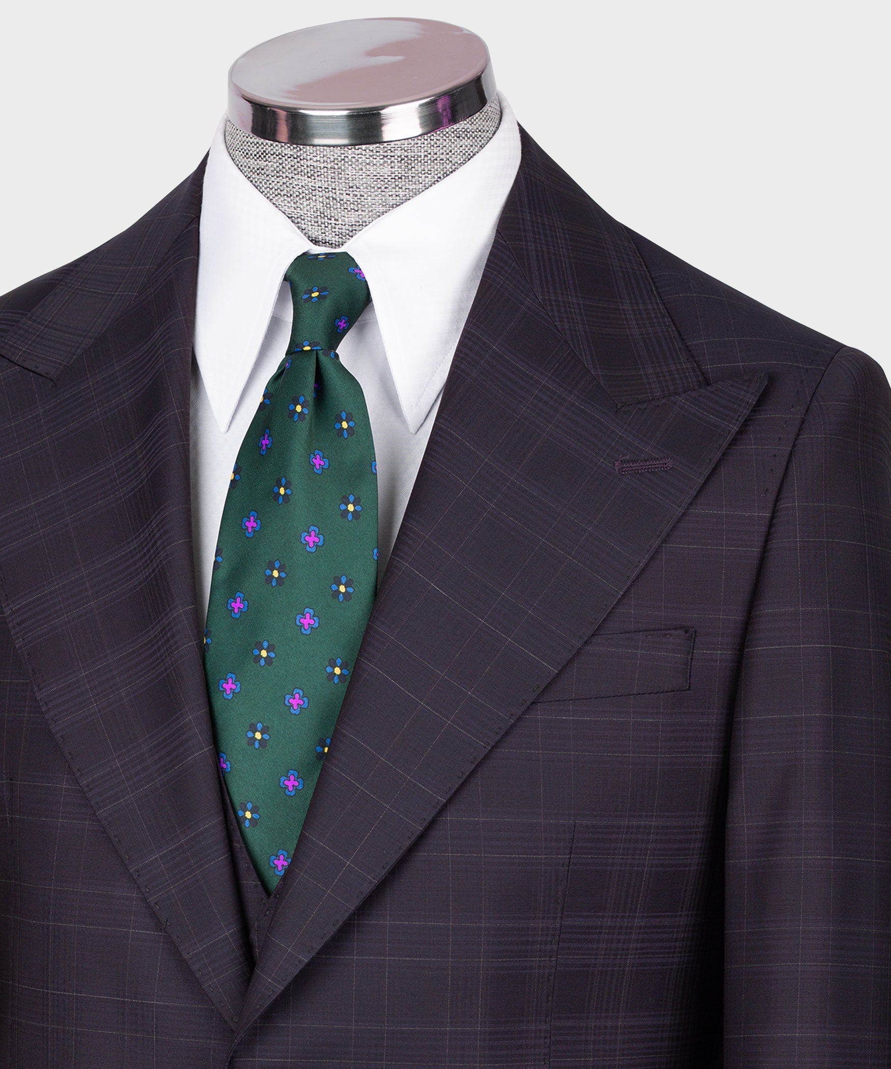 Navy plaid blazer with white shirt and green floral tie, notch lapels and pocket square
