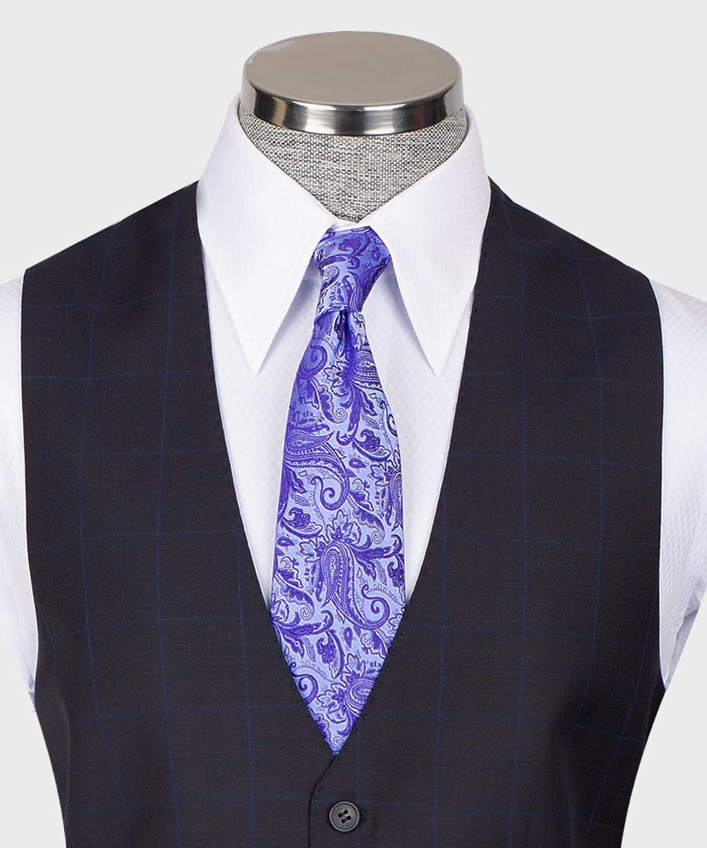 Dark vest suit with white shirt and purple paisley tie; vest button closure