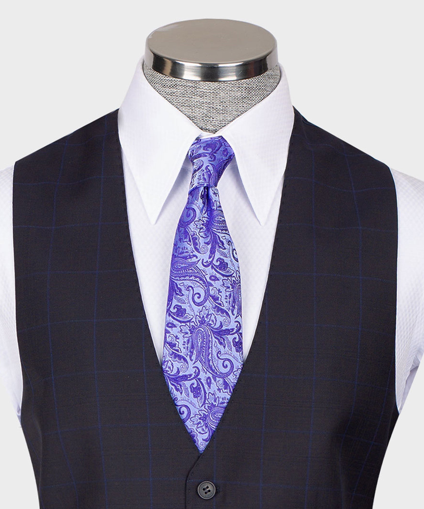 Dark vest suit with white shirt and purple paisley tie; vest button closure
