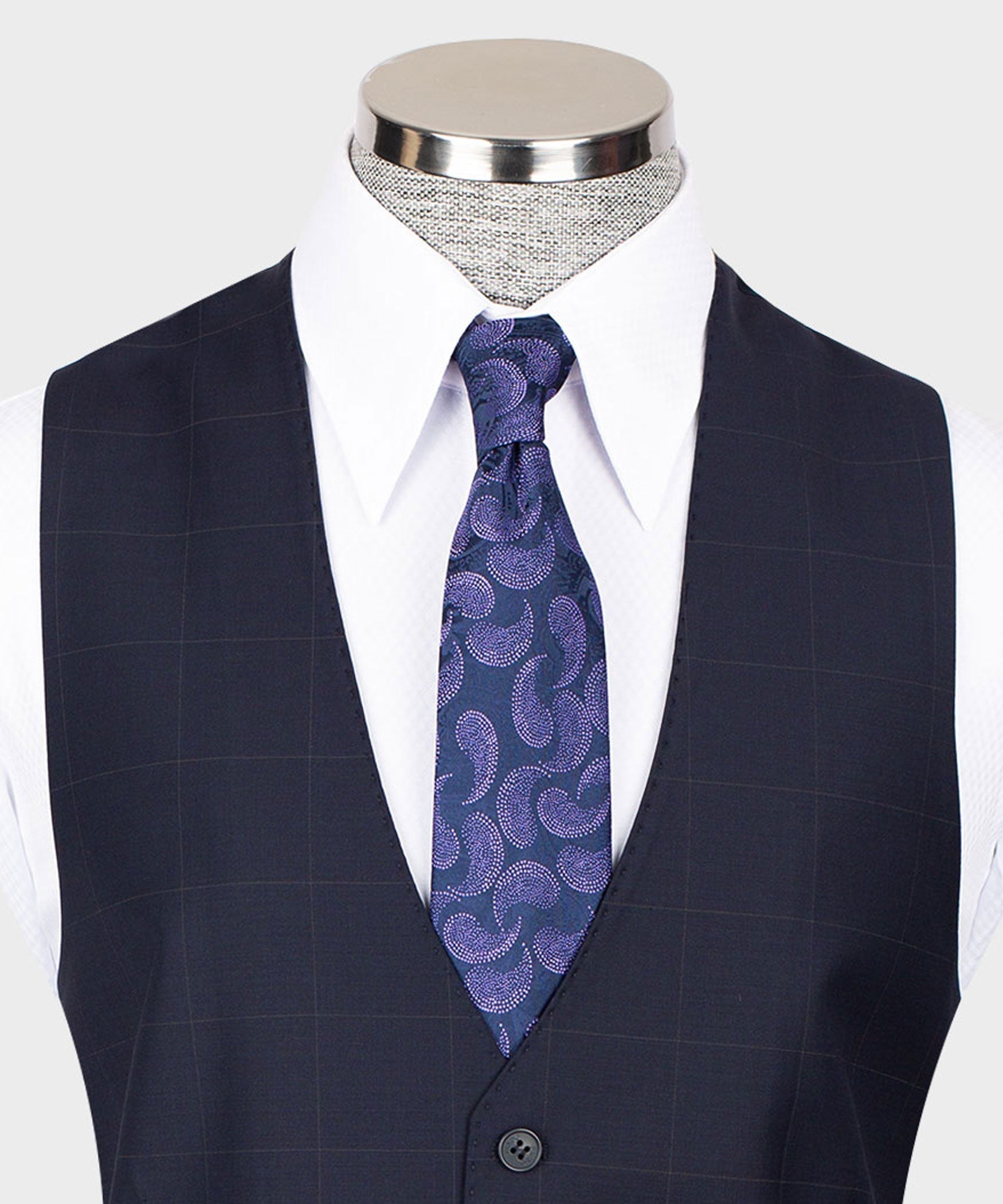 Navy vest with white dress shirt and purple patterned necktie