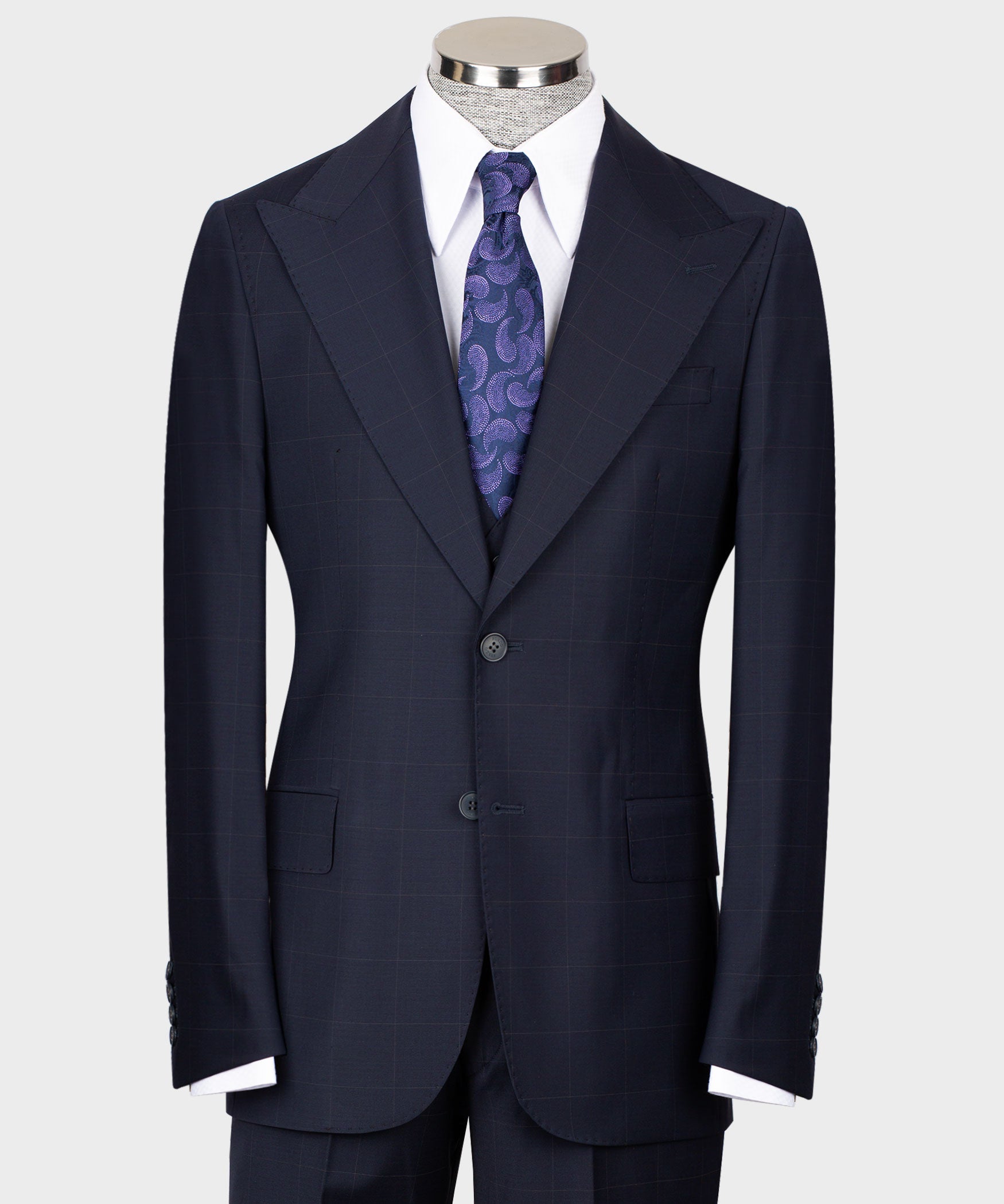 Navy tailored three-piece suit: jacket, vest, white shirt, purple patterned tie
