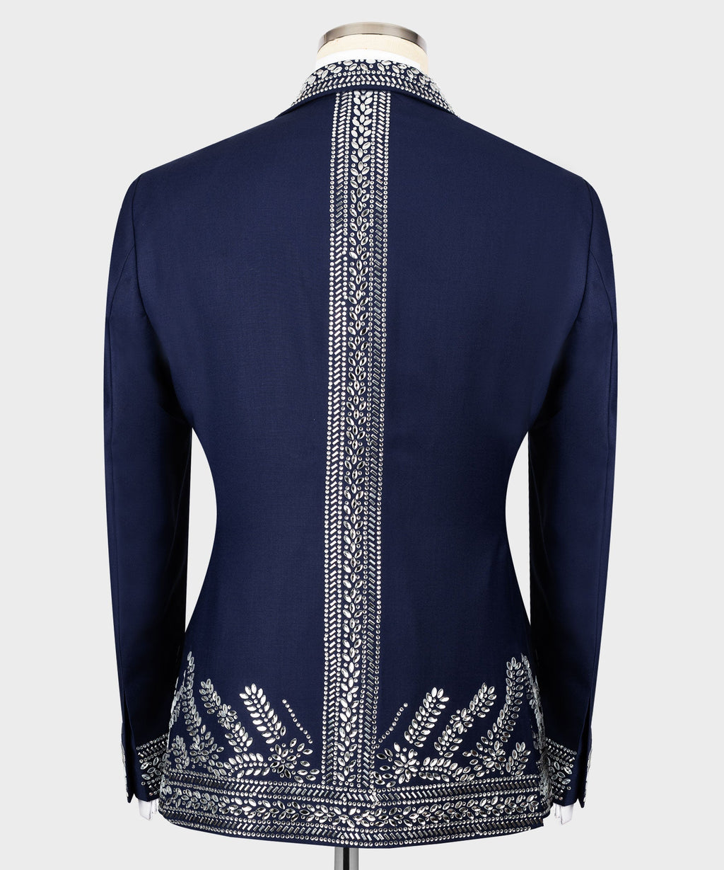 Back view of dark blue tuxedo jacket with vertical silver stone trim and decorative hem