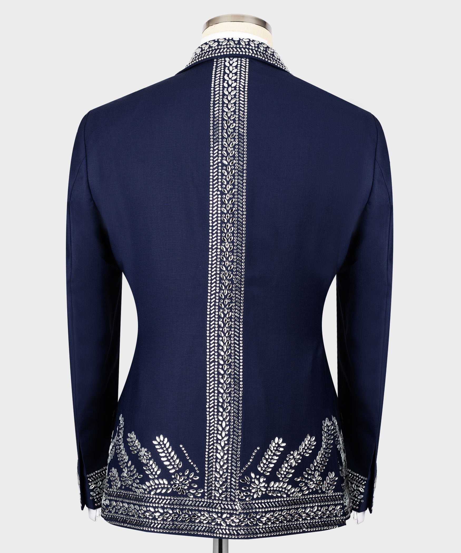 Back view of dark blue tuxedo jacket with vertical silver stone trim and decorative hem