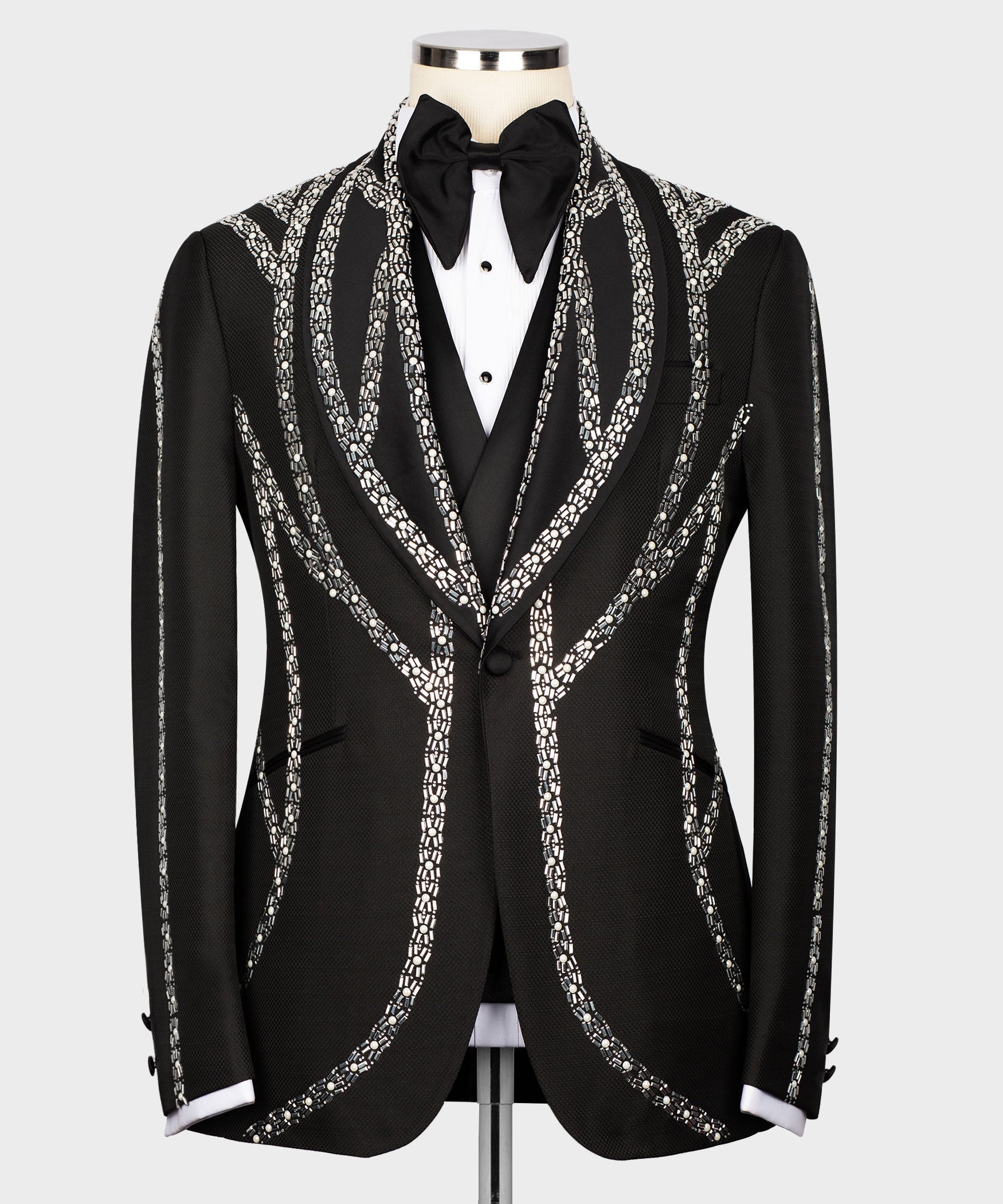 Black tuxedo jacket with silver embroidered trim, bow at neckline