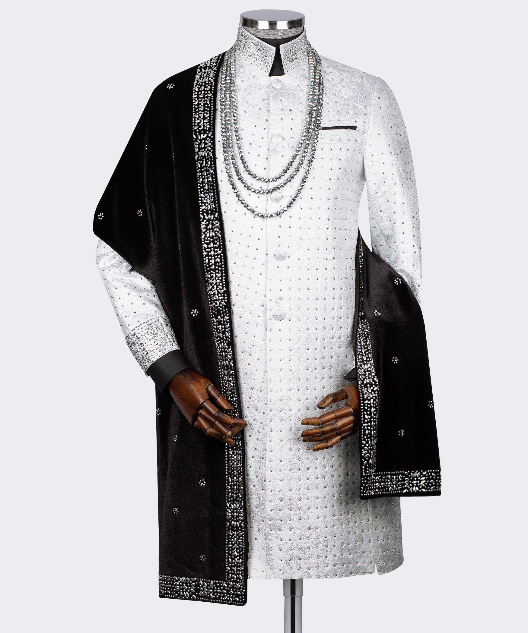 White tuxedo-style jacket with black embellished drape and rhinestone necklace