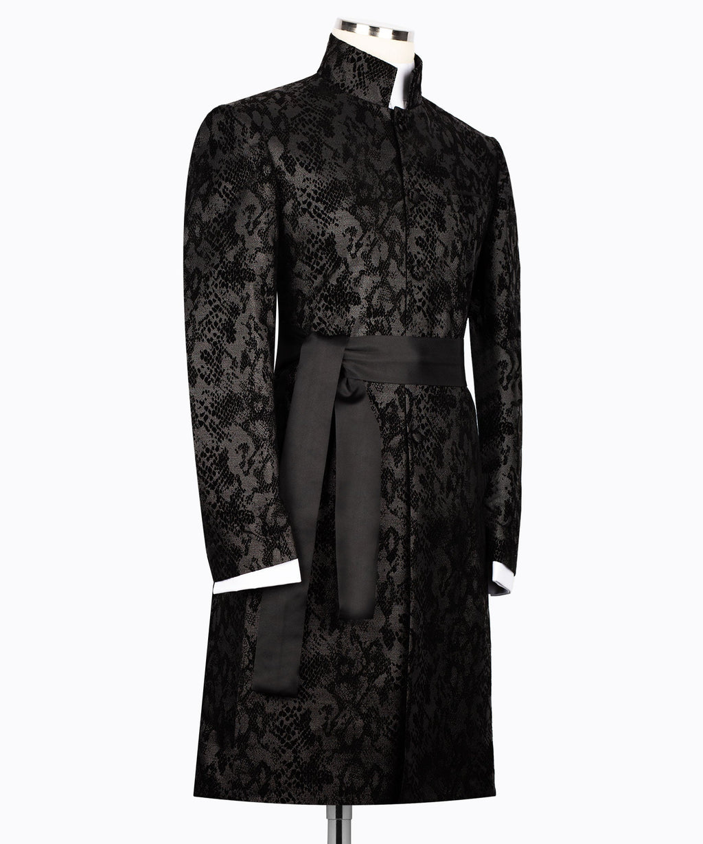 Black snake-print tuxedo jacket with long belt draped at waist, button front, long sleeves