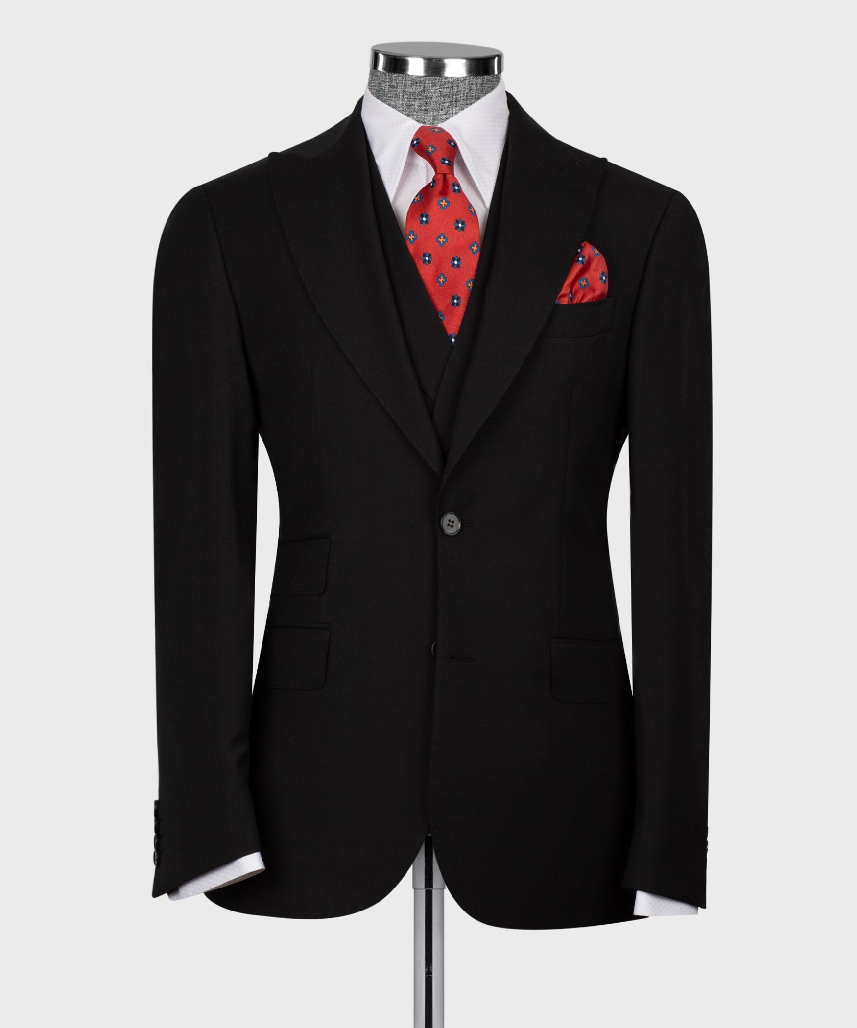 Black blazer and vest front with red patterned tie plus pocket square.