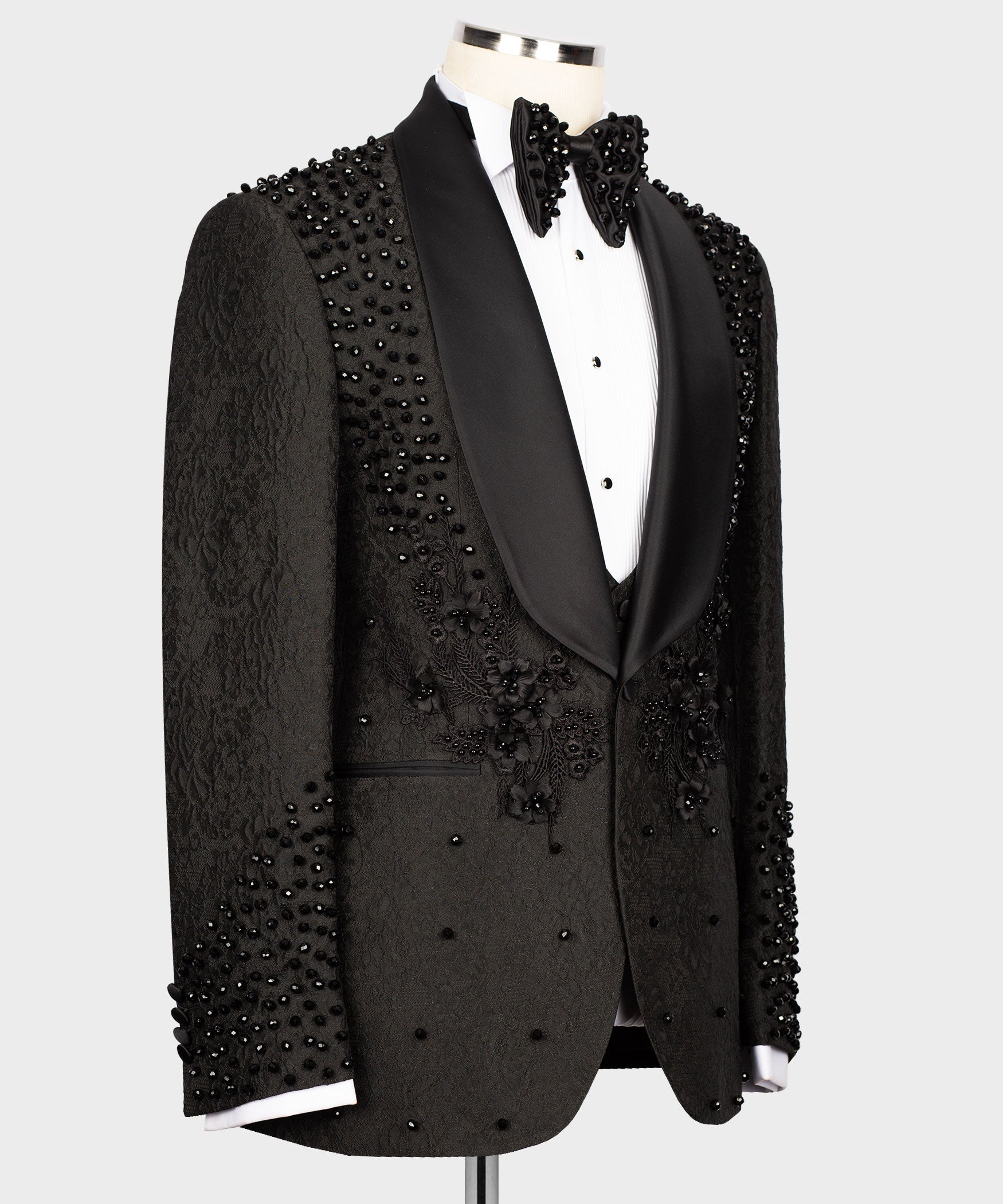 Black tuxedo blazer front view with bow-collar detailing and bead-embroidered panels