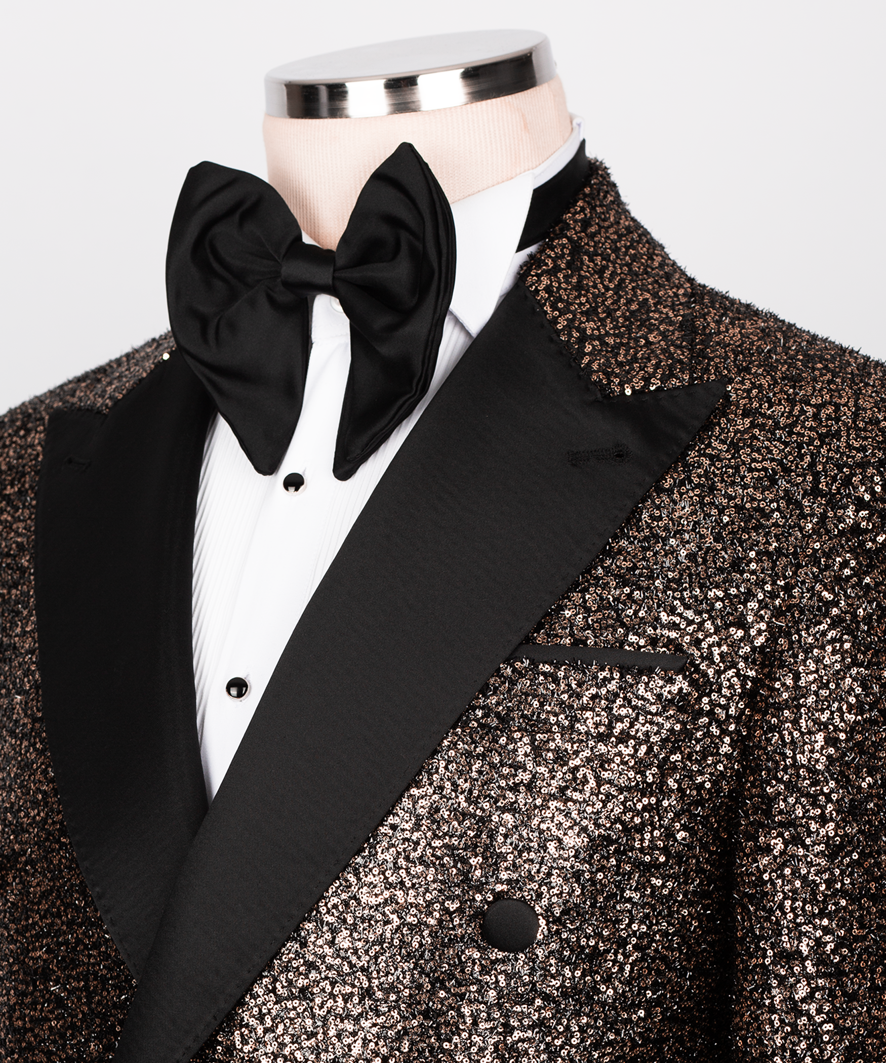Close-up: black bow tie and satin-trim tuxedo shirt with copper sequin lapel
