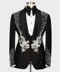 Black tuxedo suit with stone-embroidered lapels and floral vest appliqué, bow tie