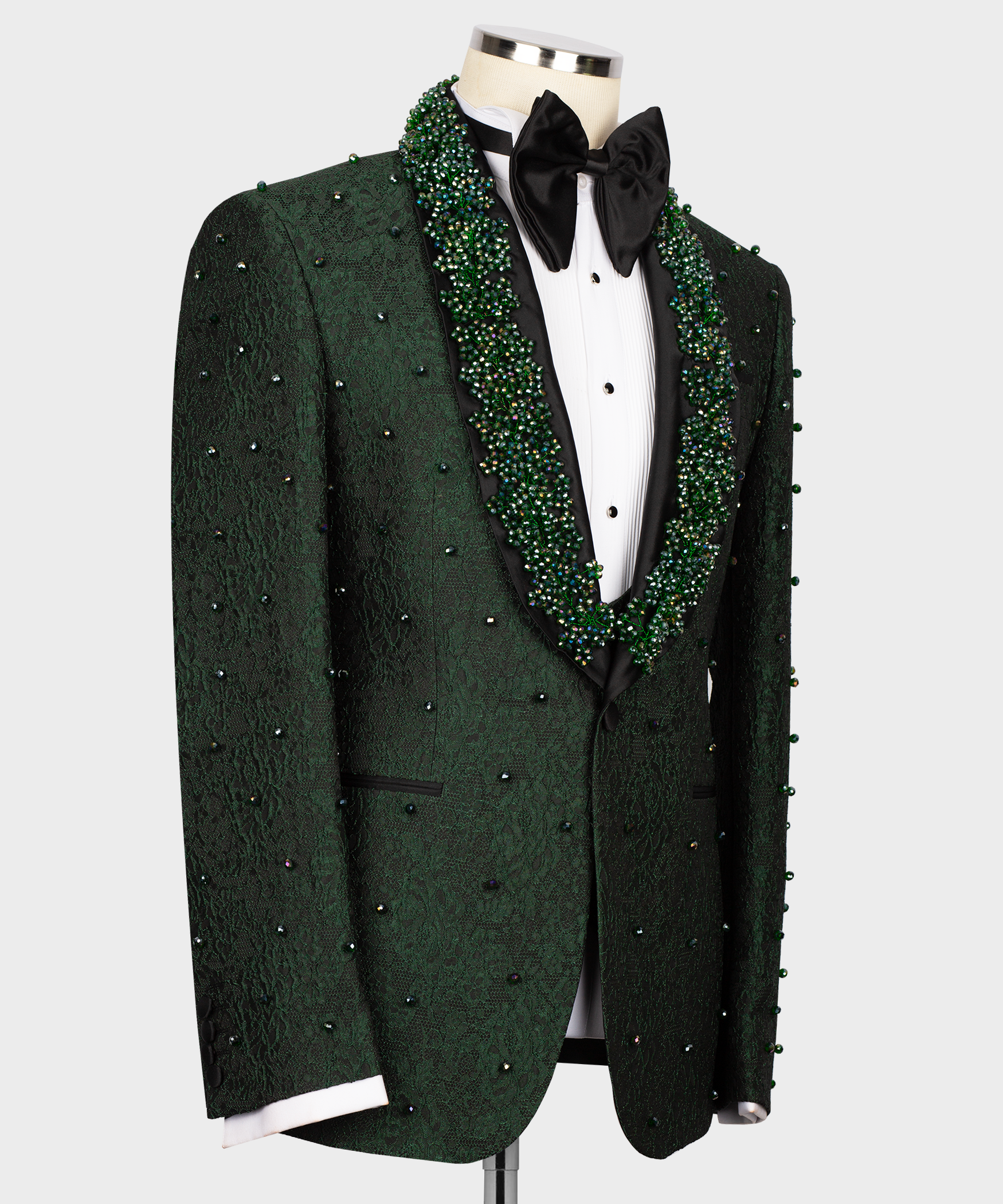 Green tuxedo suit with black bow tie, buttoned vest, and sparkly beaded lapel trim