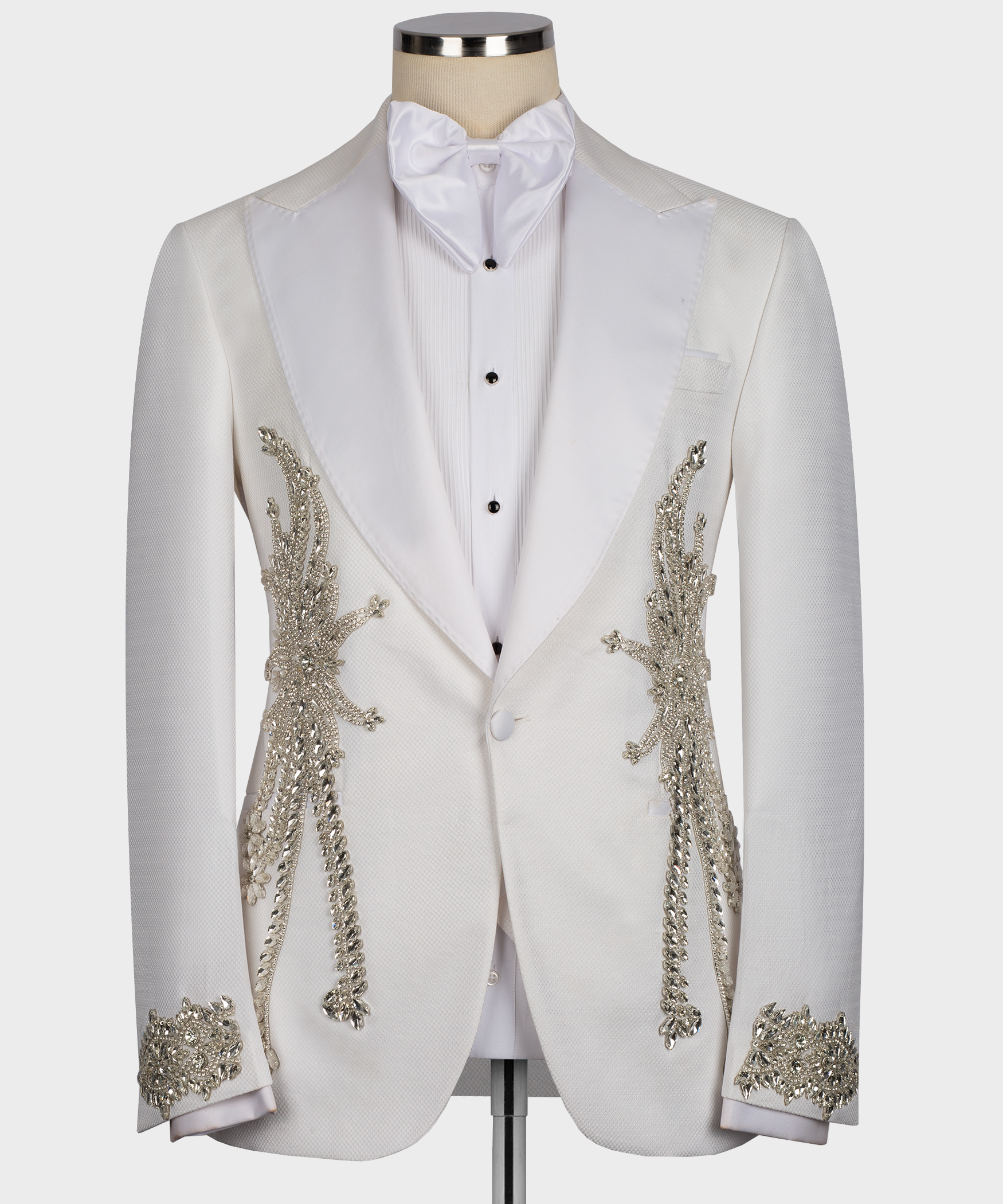 White tuxedo suit jacket with ornate stone-like embroidery on lapels and cuffs