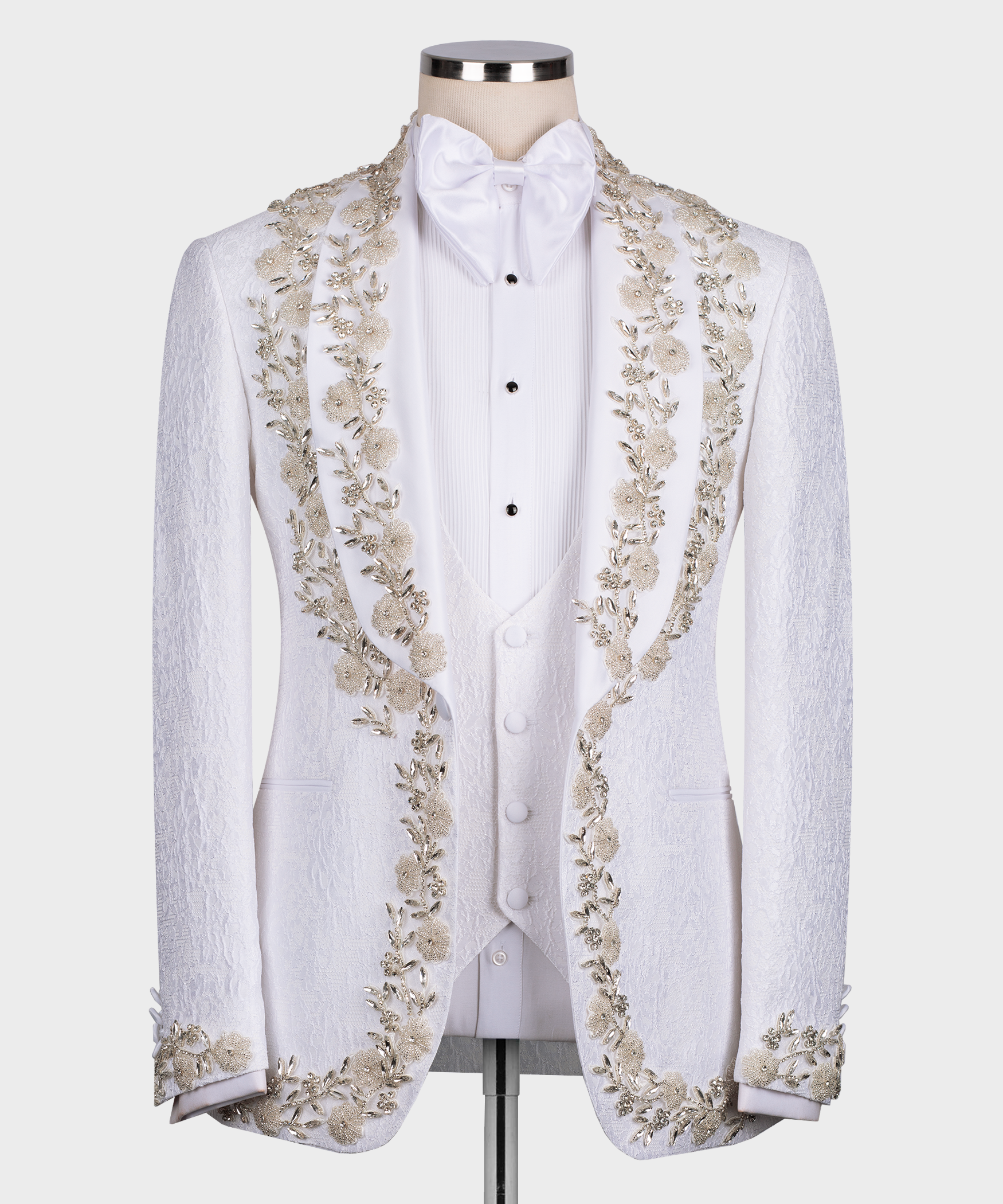 White tuxedo jacket with gold floral and stone embroidery, satin bow tie and vest front