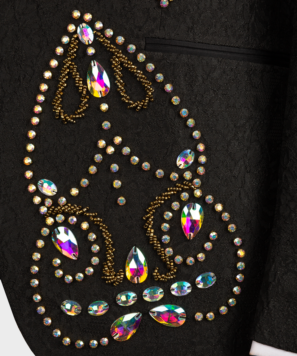 Close-up of black tuxedo lapel: gold beadwork with multicolor rhinestone accents