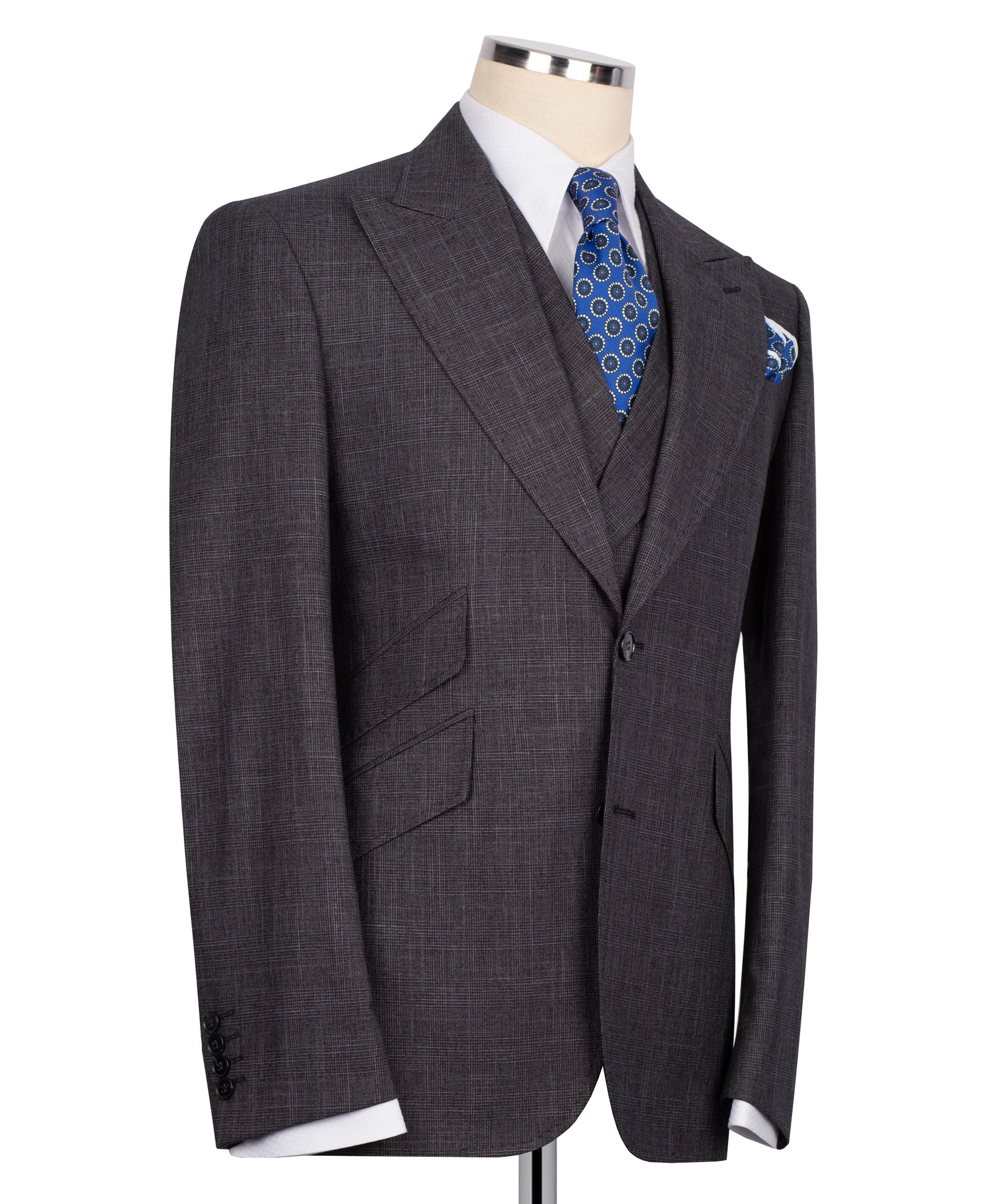 Dark plaid three-piece suit jacket with vest; blue patterned tie and matching pocket square