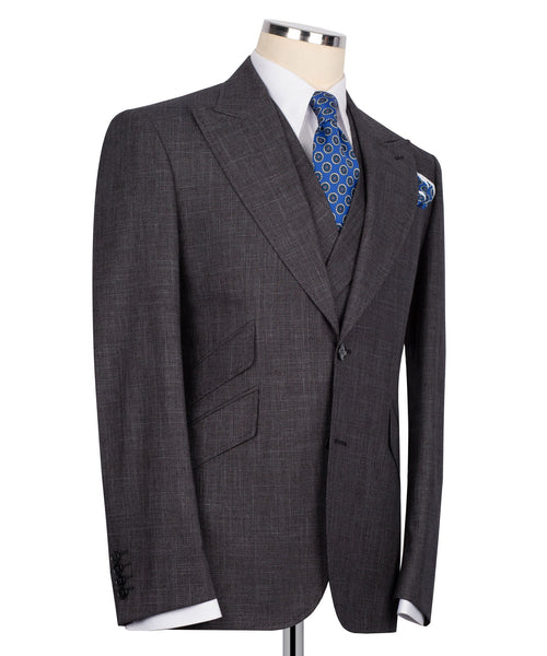Dark plaid three-piece suit jacket with vest; blue patterned tie and matching pocket square