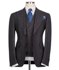 Plaid three-piece vest suit: dark jacket and vest with blue patterned tie and pocket square