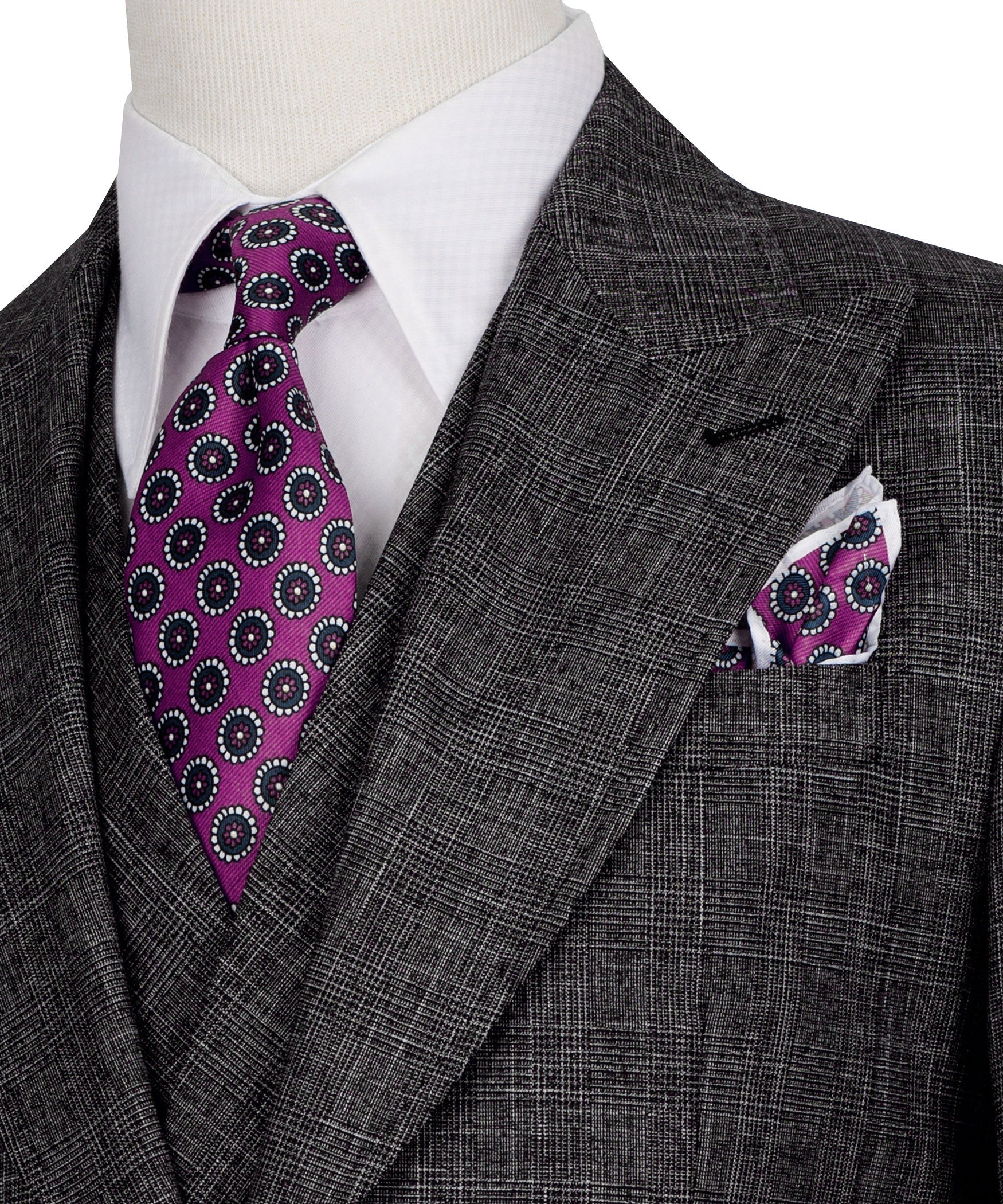 Purple patterned tie with matching pocket square on black plaid suit jacket
