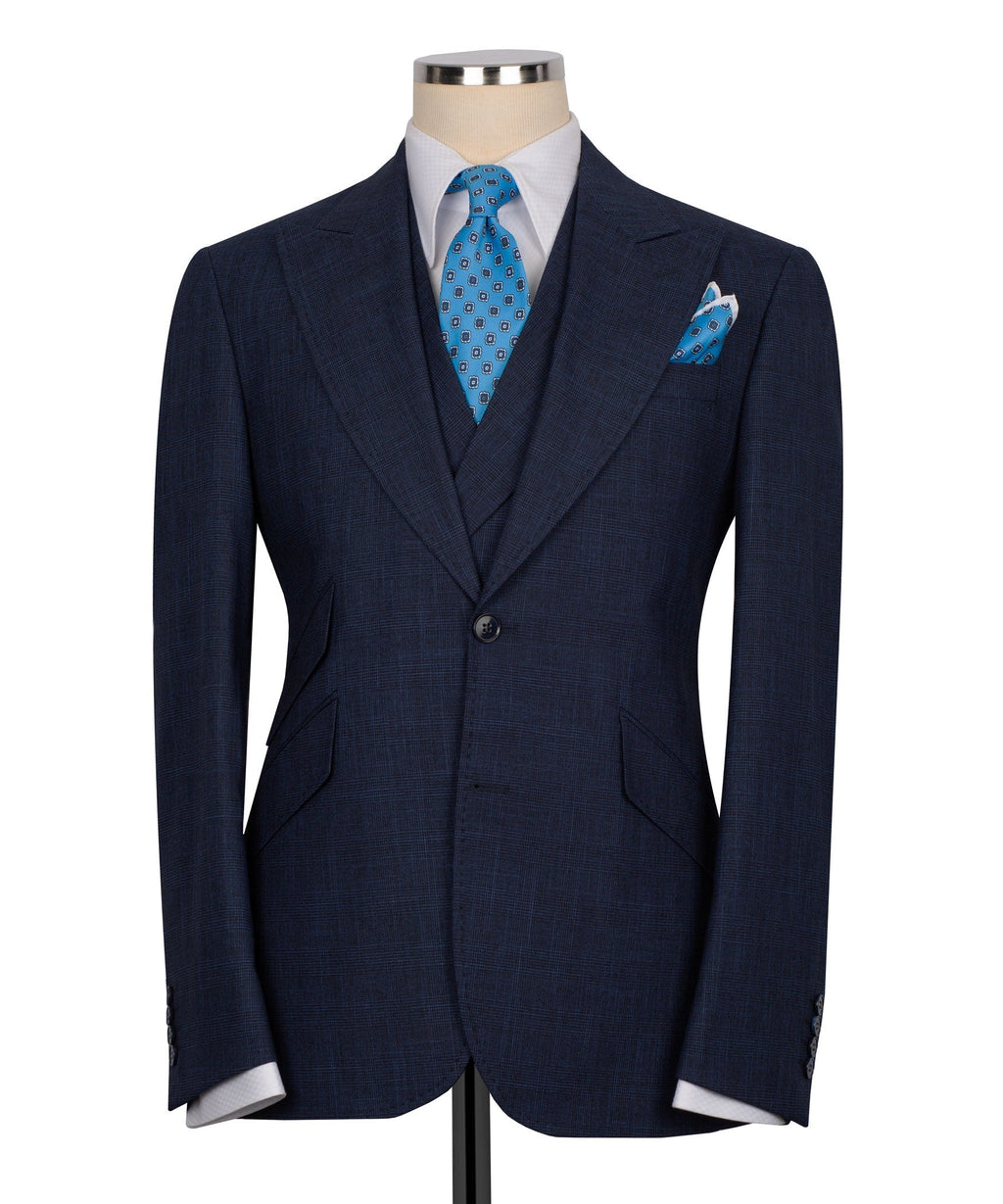 Dark navy men's three-piece vest suit with blue patterned tie and matching pocket square