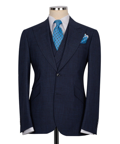 Dark navy men's three-piece vest suit with blue patterned tie and matching pocket square