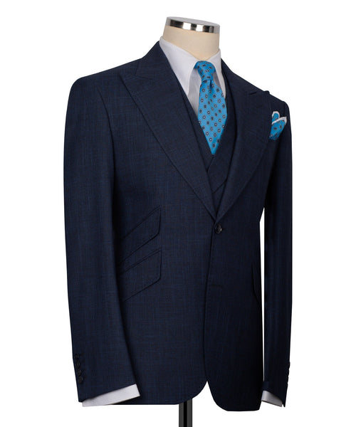 Dark navy three-piece suit jacket with blue patterned tie and pocket square, side view