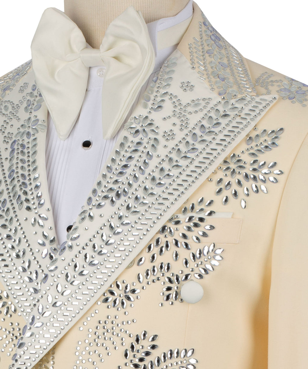 Close-up: light yellow tuxedo lapel with silver stones, white bow tie and shirt