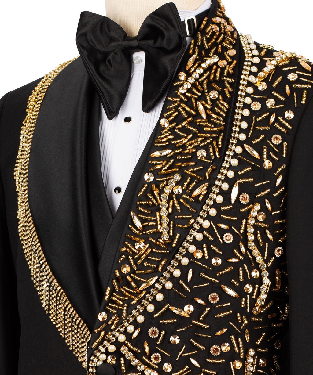 Close-up: black tuxedo bow tie with gold and pearl stone embroidery on vest