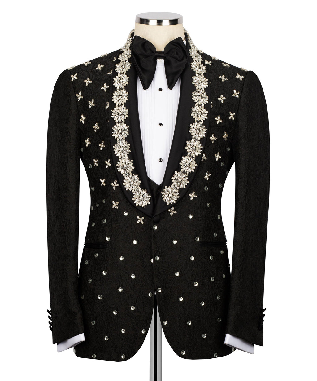 Black tuxedo jacket with central floral vine embroidery and bow at neckline over vest