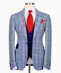 Light blue plaid suit jacket with notched lapels and flap pocket, navy buttons