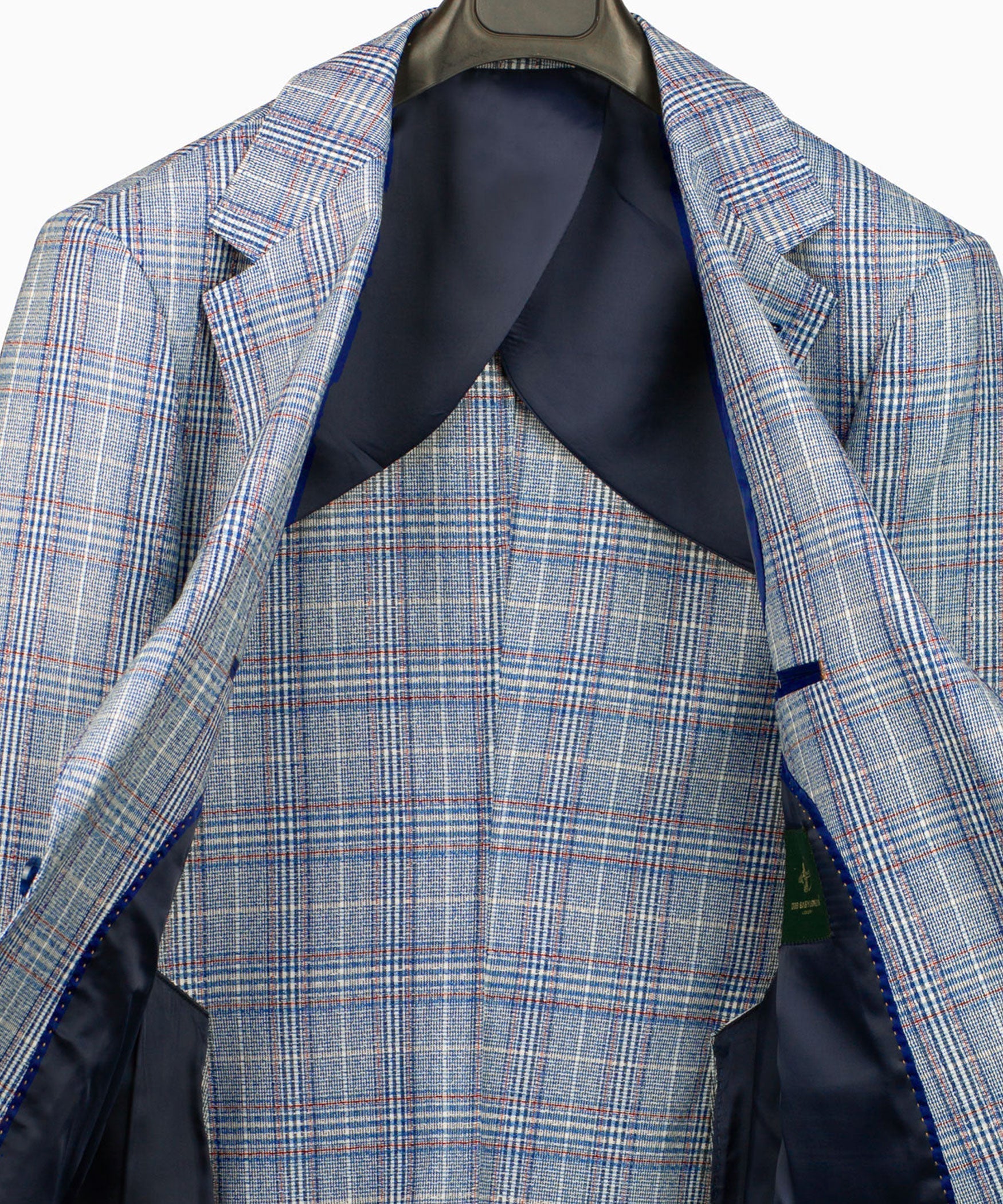 Light blue plaid suit jacket interior with dark lining and pocket flap