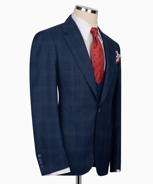 Dark blue plaid suit jacket with red patterned tie and white pocket square